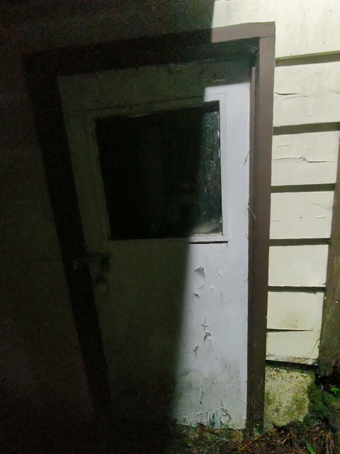 A short video loop of a scary-looking door, mostly obscured by shadow
